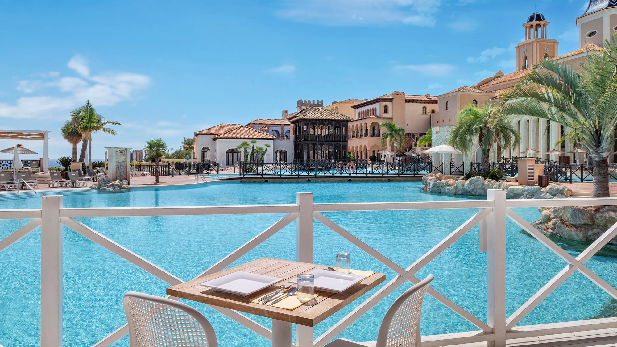 a table and chairs by a pool