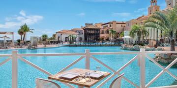a table and chairs by a pool