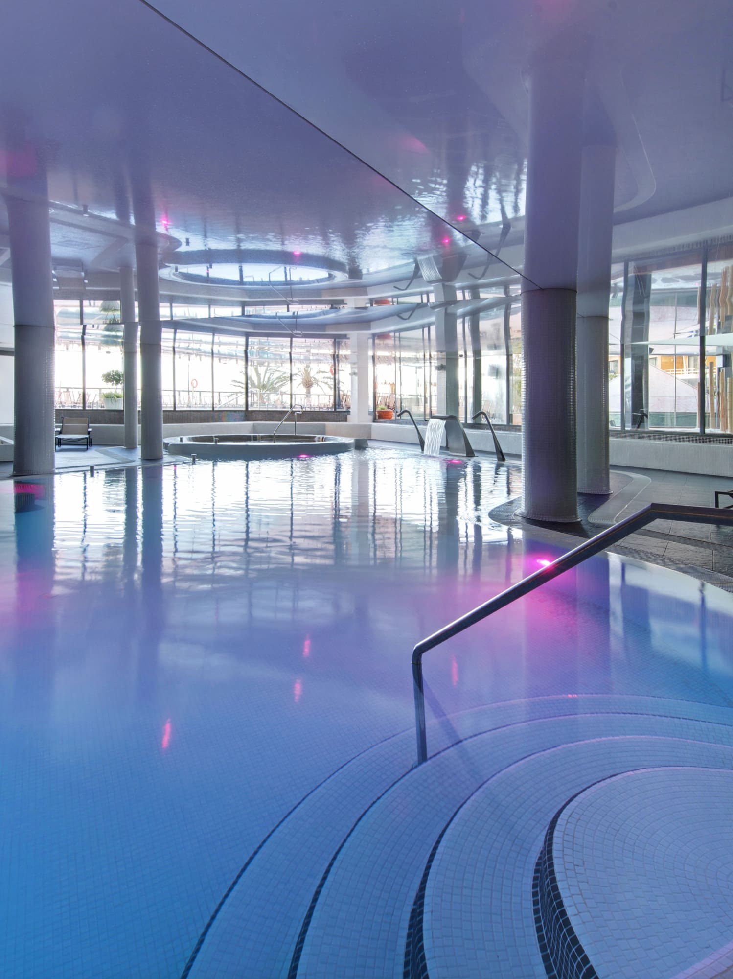 a large indoor pool with a staircase