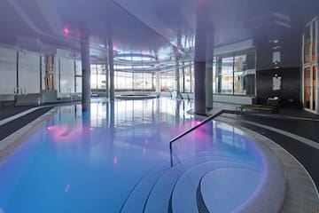 a pool with chairs and a red object in it