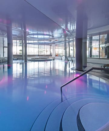 a large indoor pool with a staircase