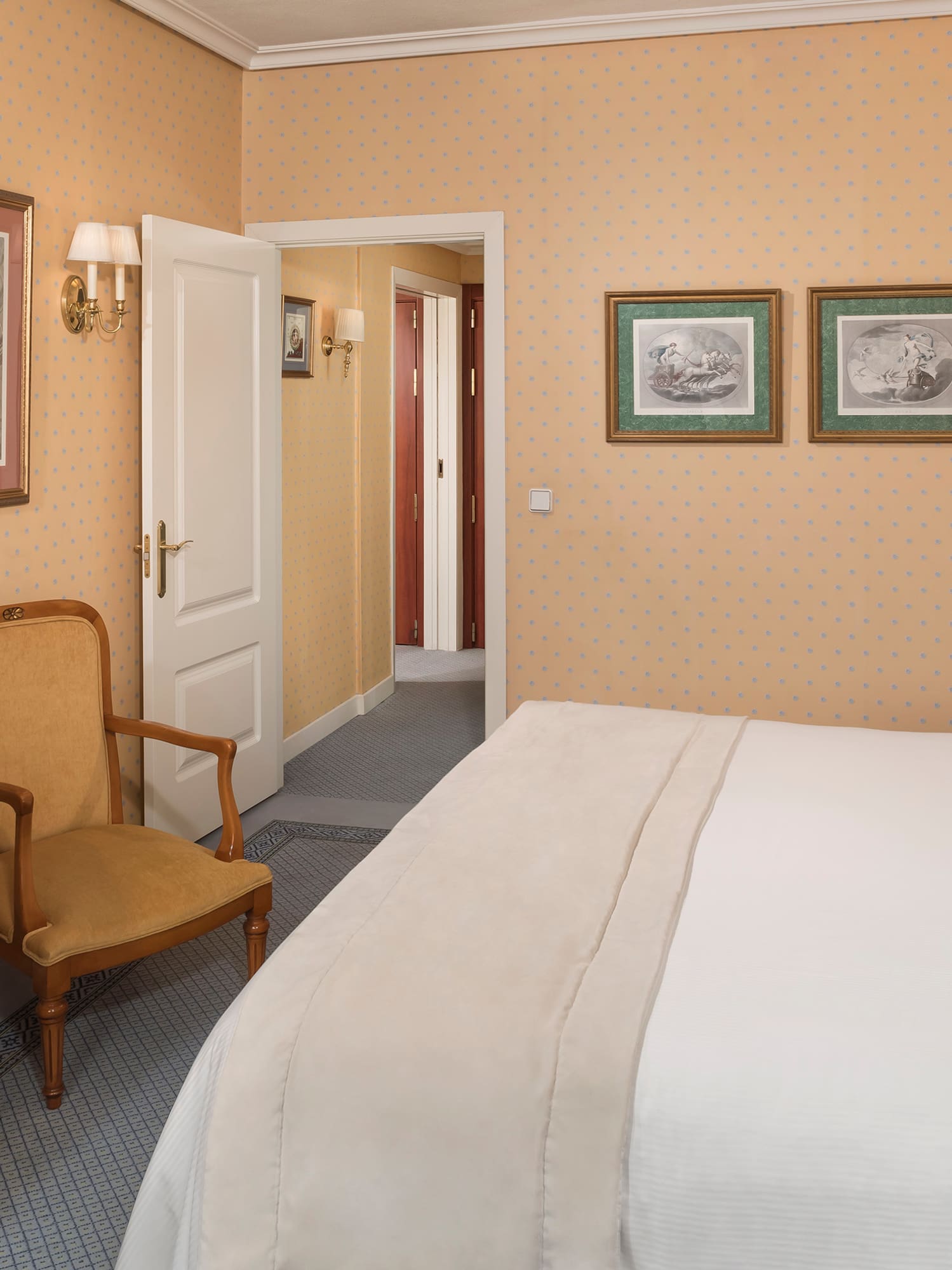 a bedroom with a bed and a chair