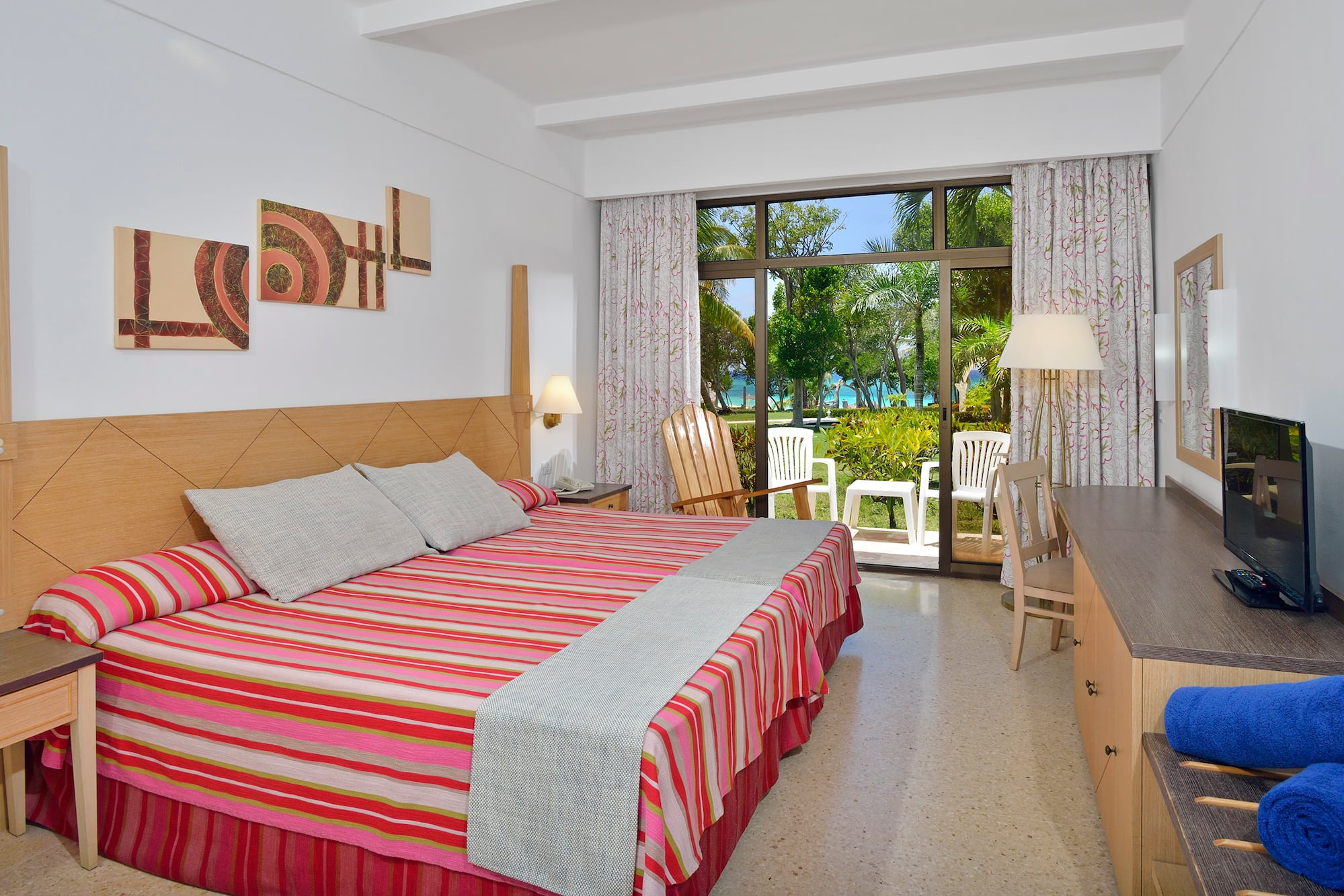 a room with a bed and chairs and a table