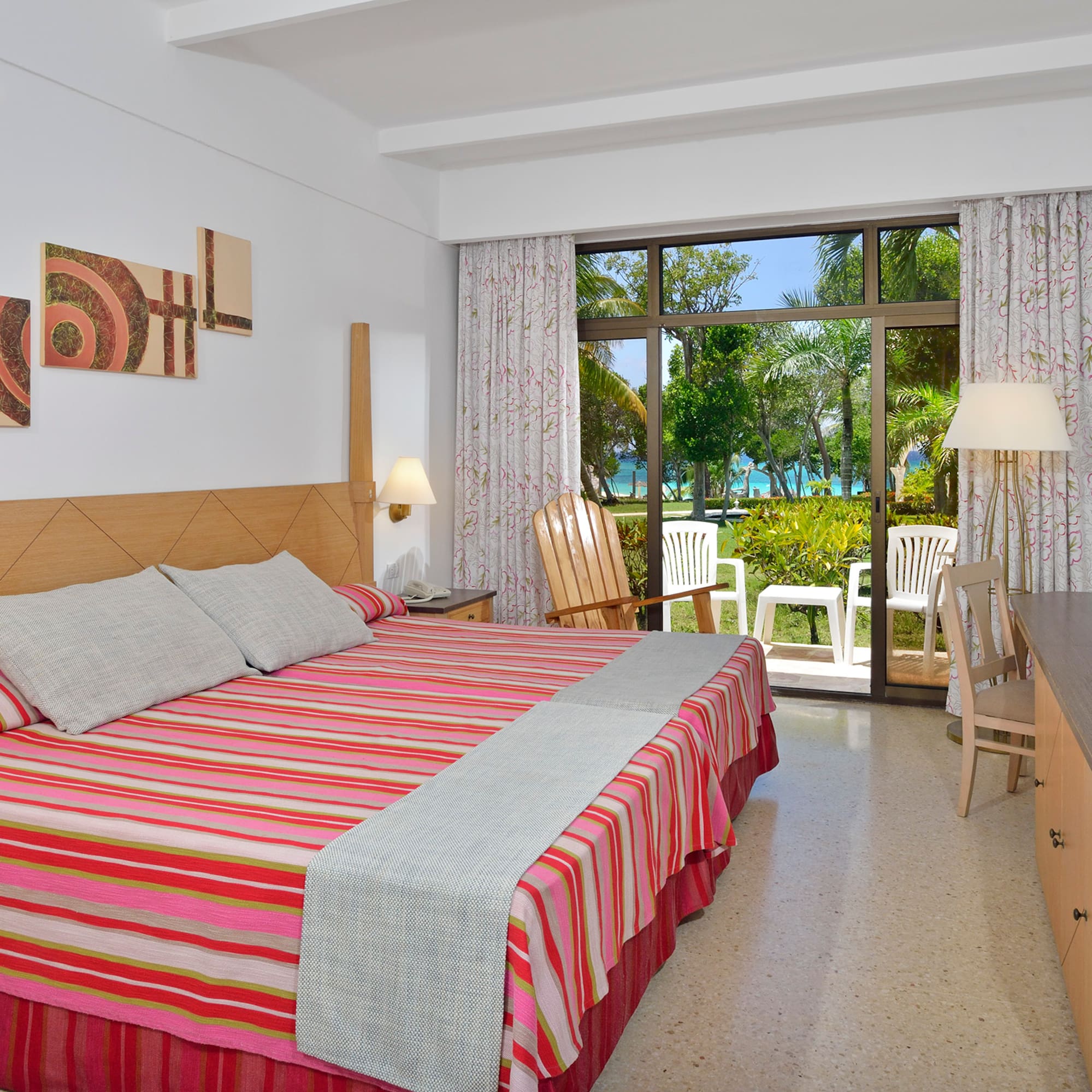 a room with a bed and chairs and a table