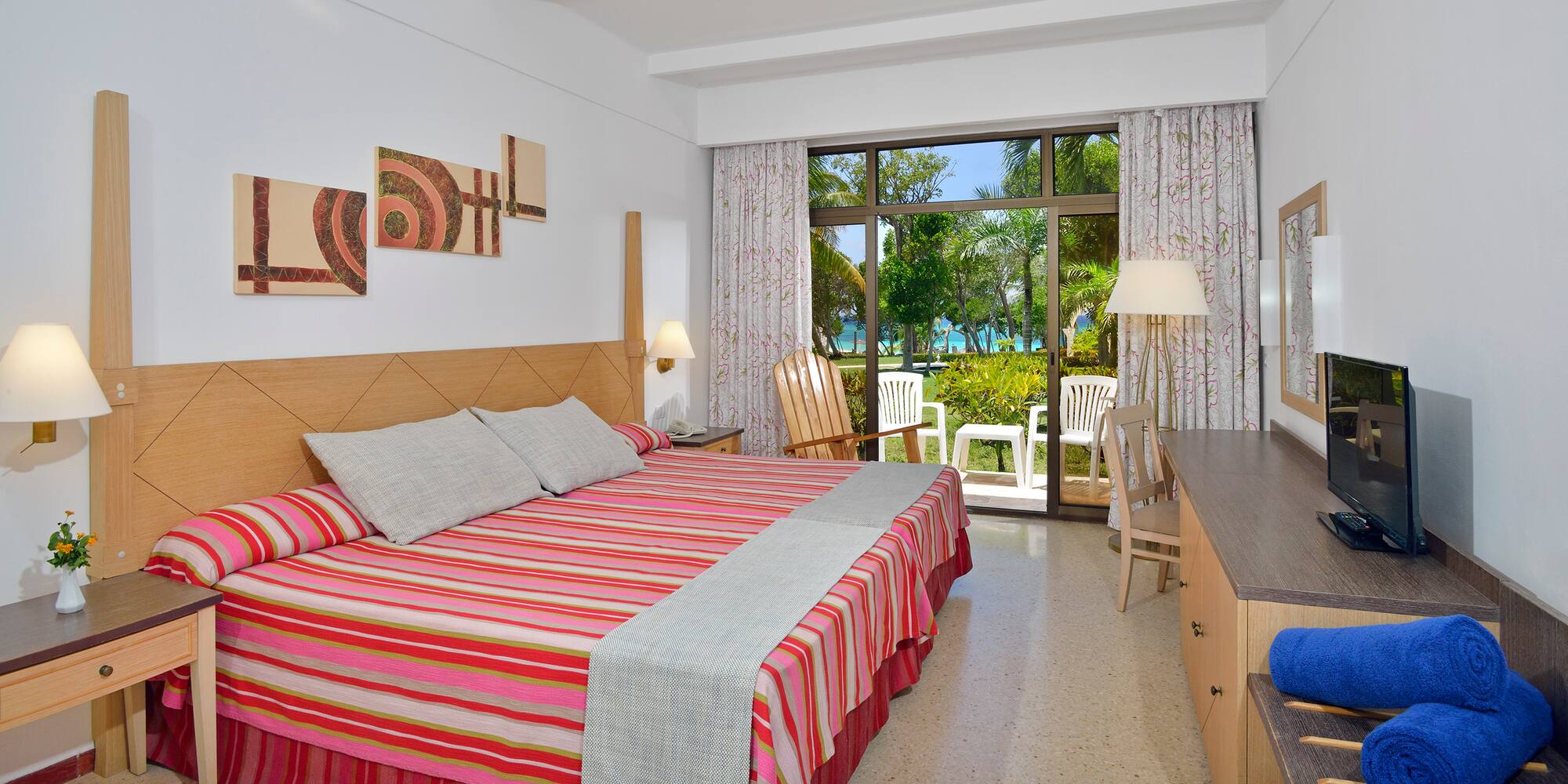 a room with a bed and chairs and a table