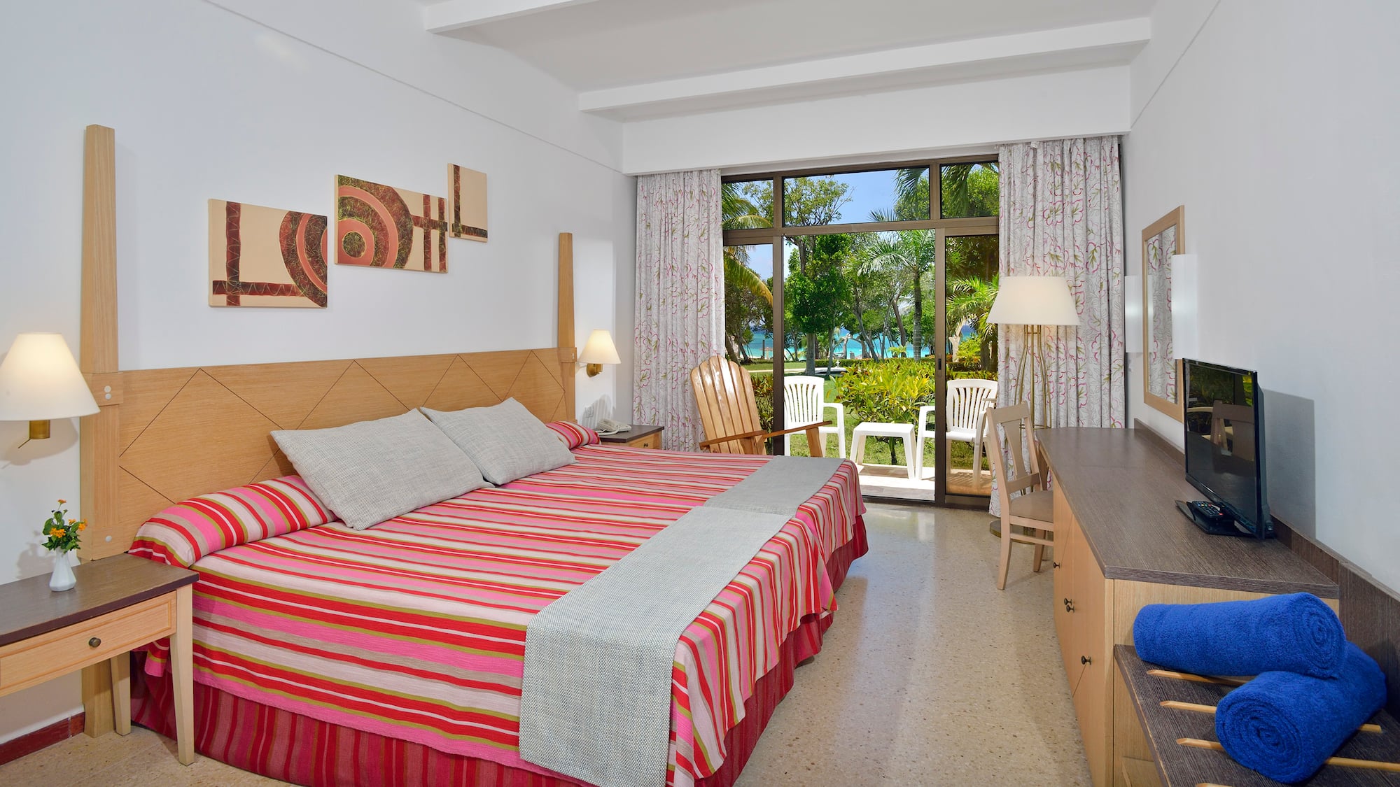 a room with a bed and chairs and a table