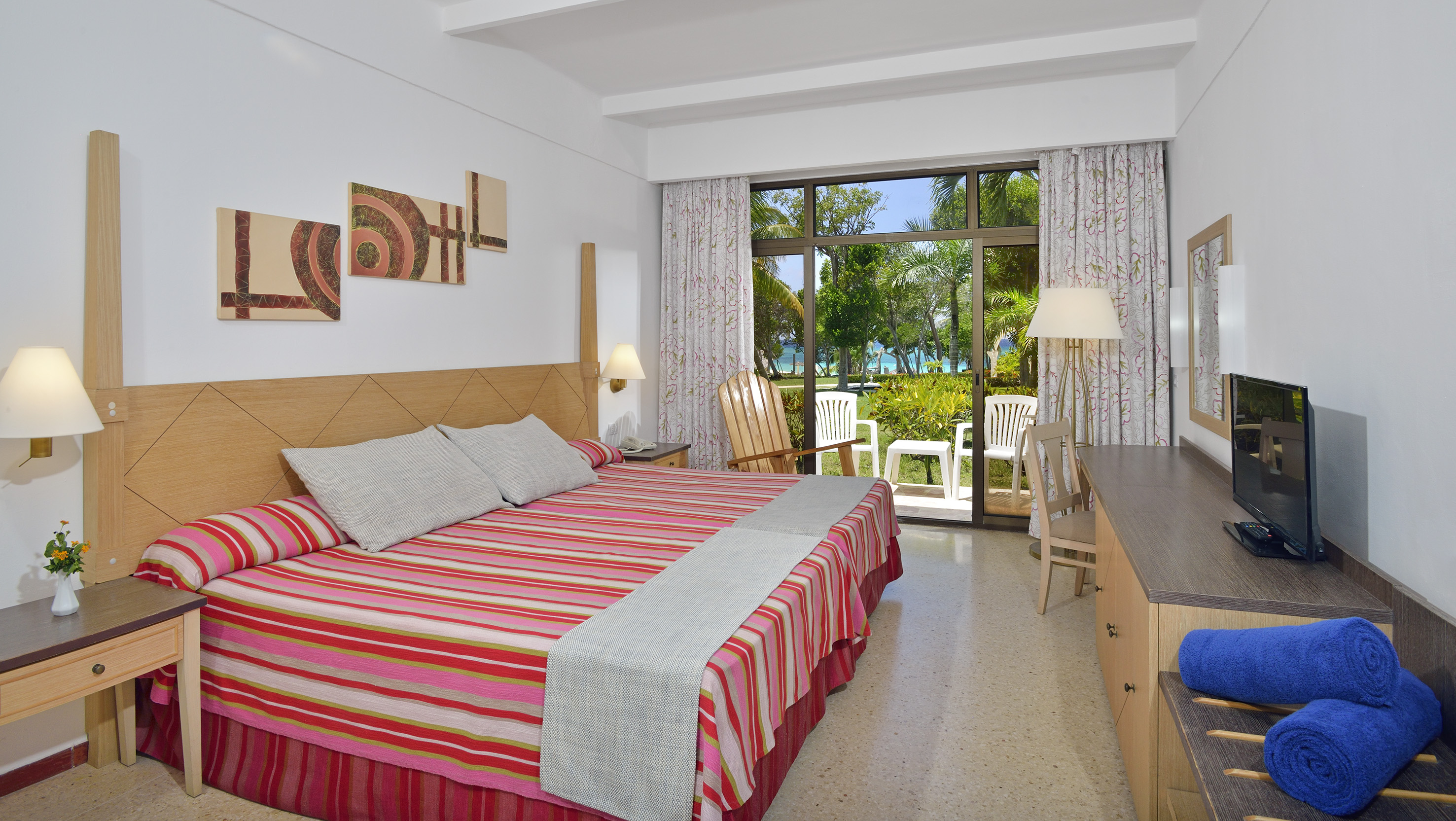 a room with a bed and chairs and a table