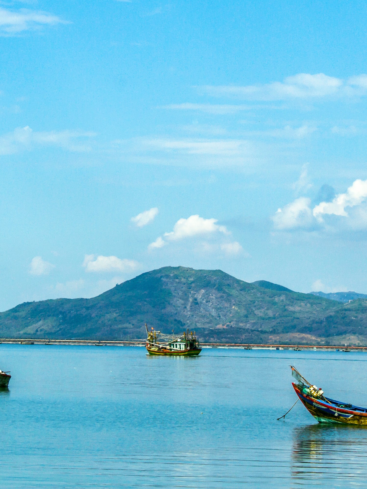 boats in the water with mountains in the background
