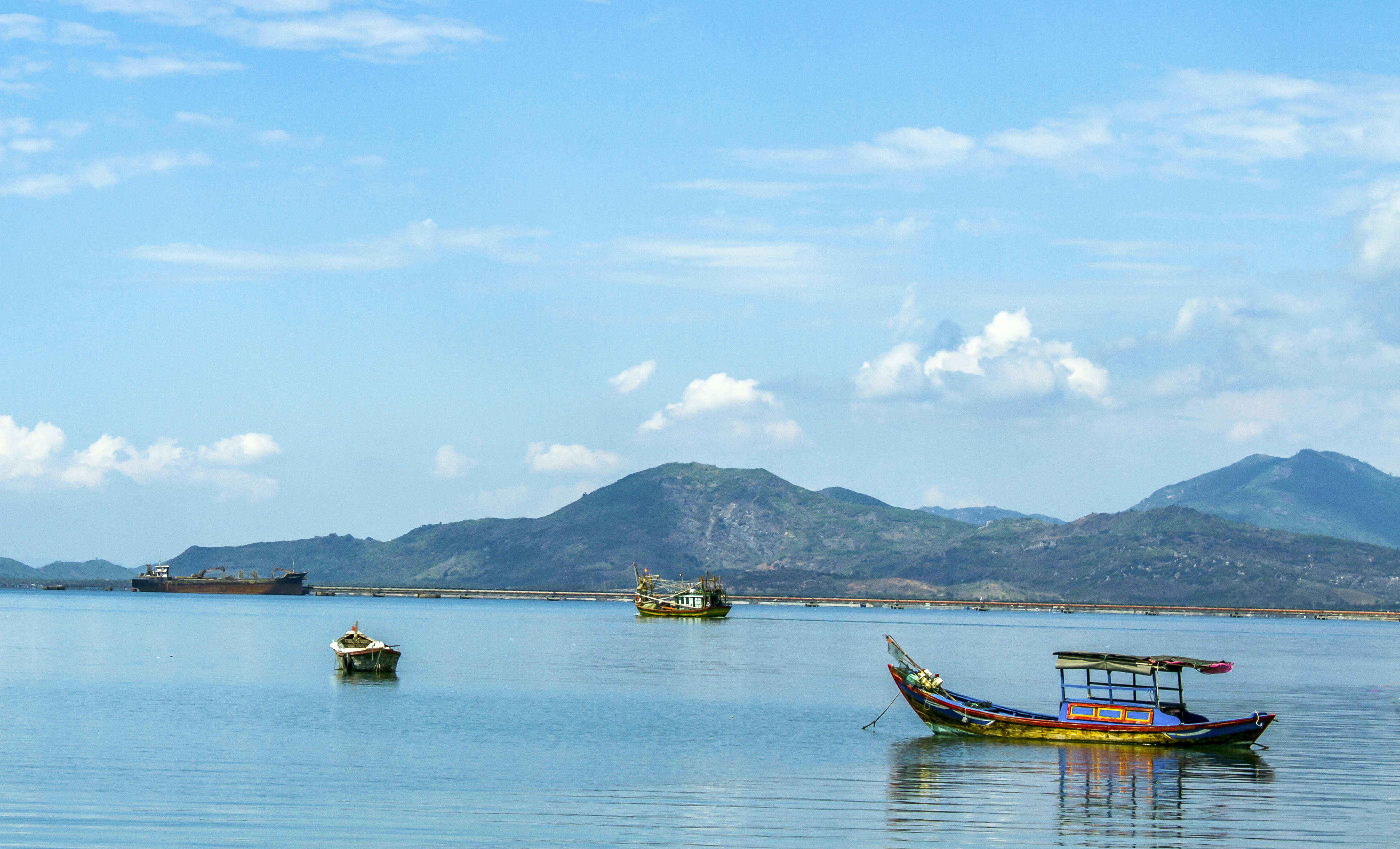 boats in the water with mountains in the background