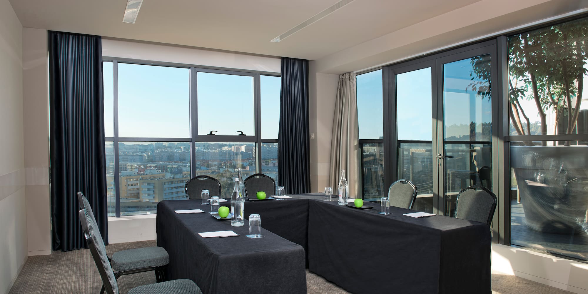 a room with black table cloths and chairs