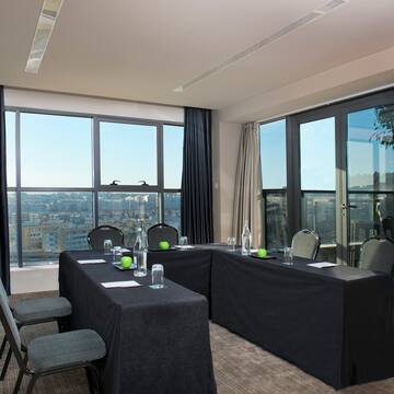 a room with black table cloths and chairs