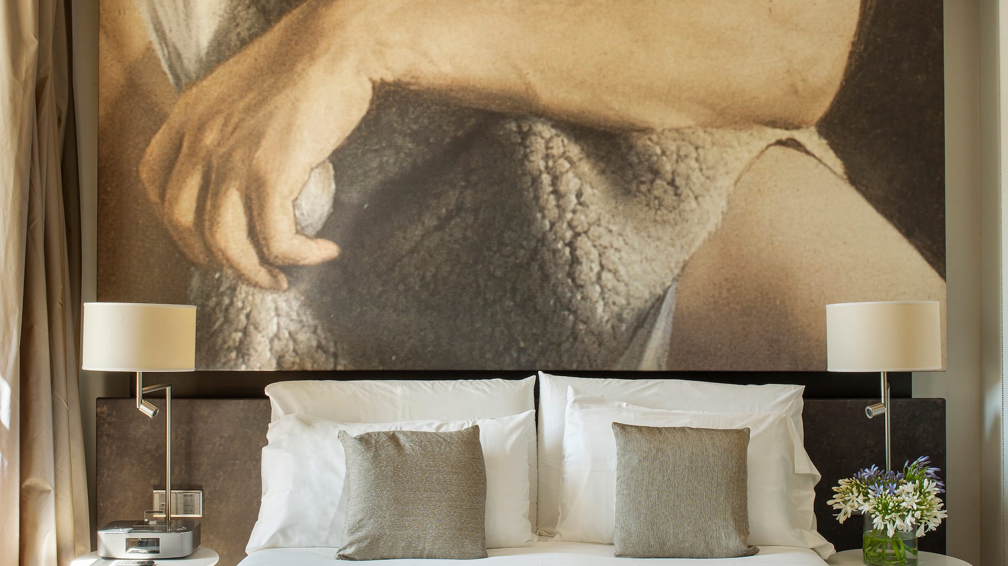 a bed with a large picture above it