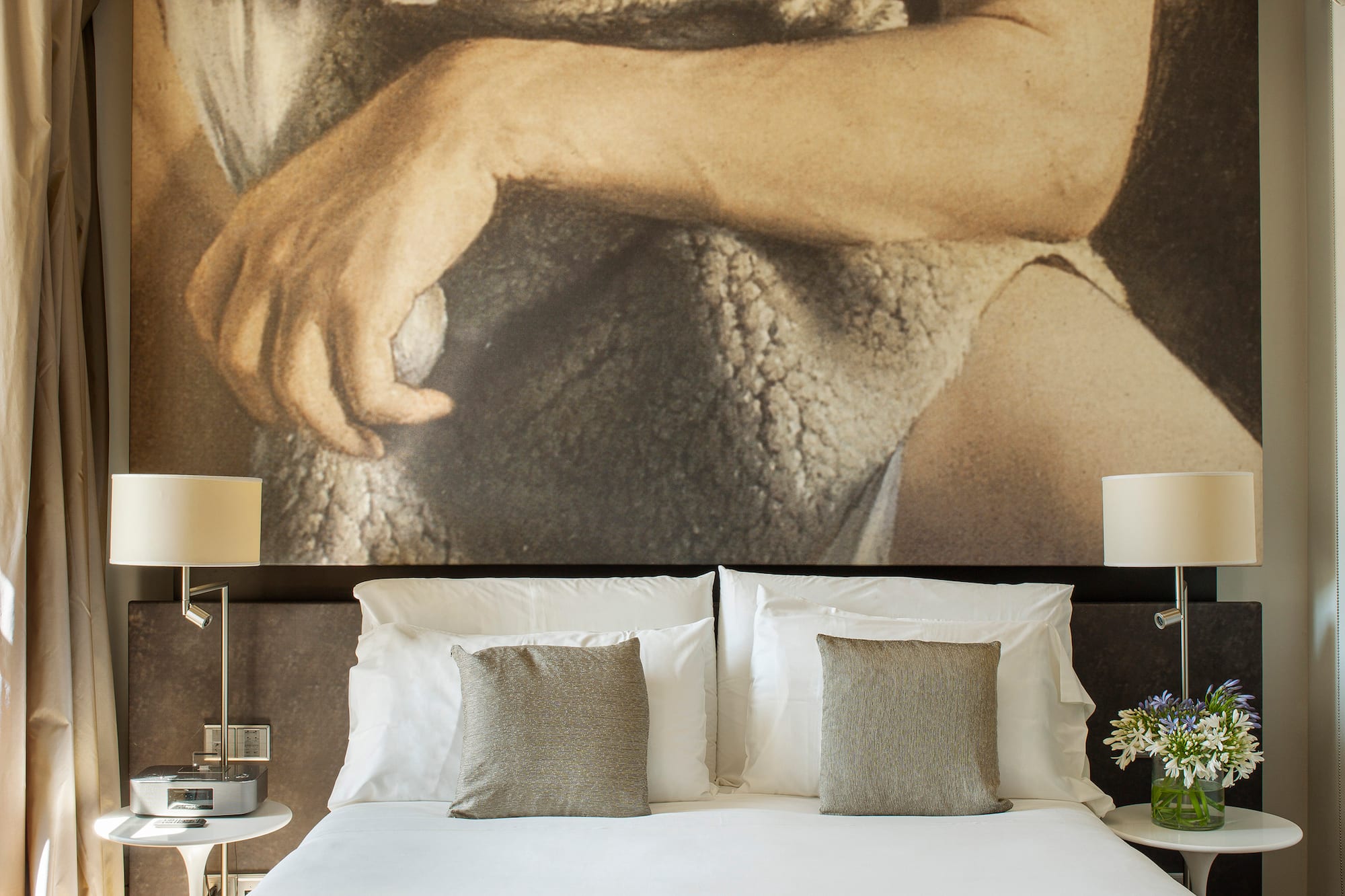 a bed with a large picture above it