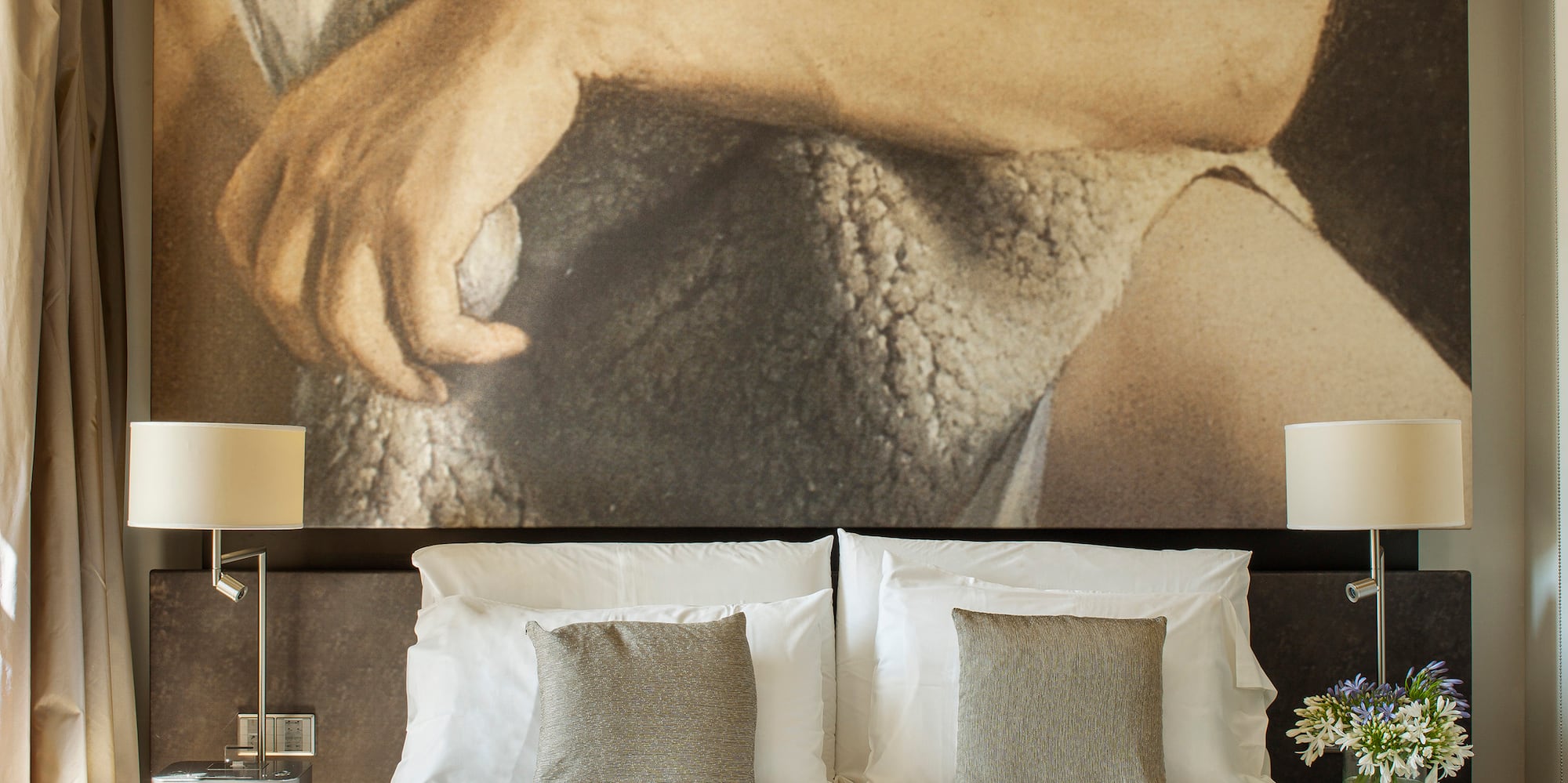 a bed with a large picture above it