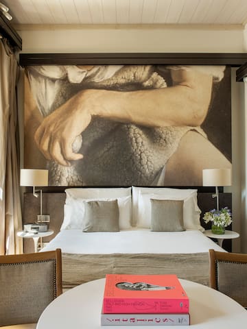 a bed with a large picture above it