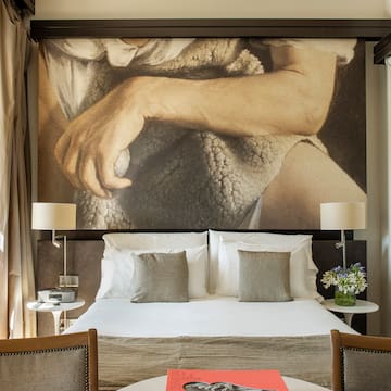 a bed with a large picture above it