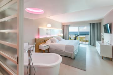 a room with a bed and bathtub