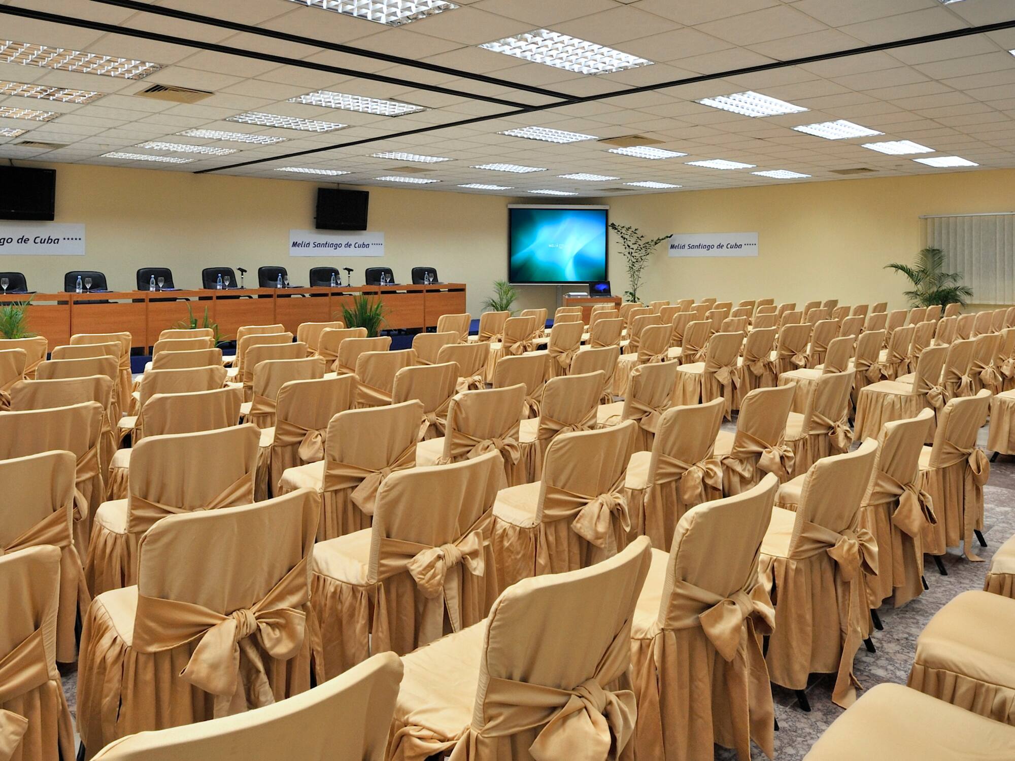 a room with chairs and a projector screen