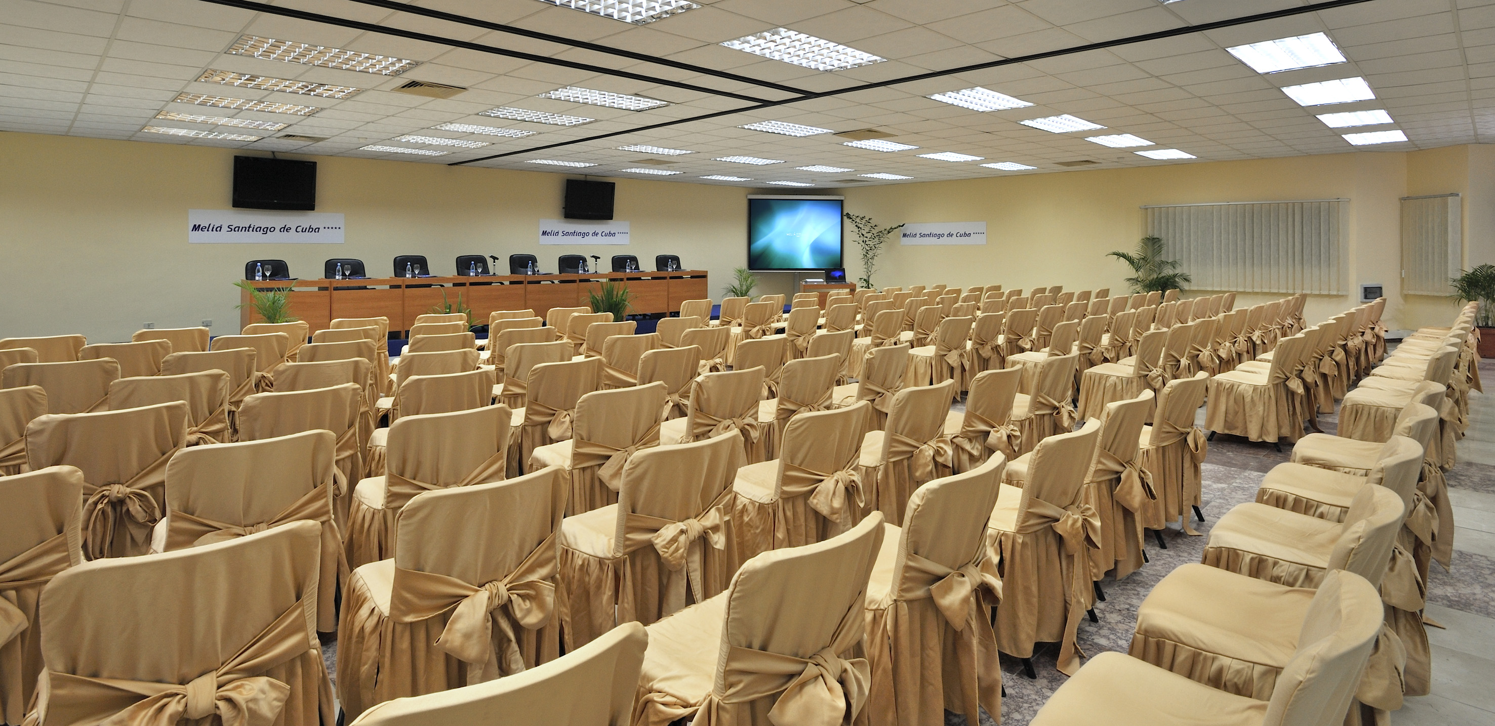 a room with chairs and a projector screen