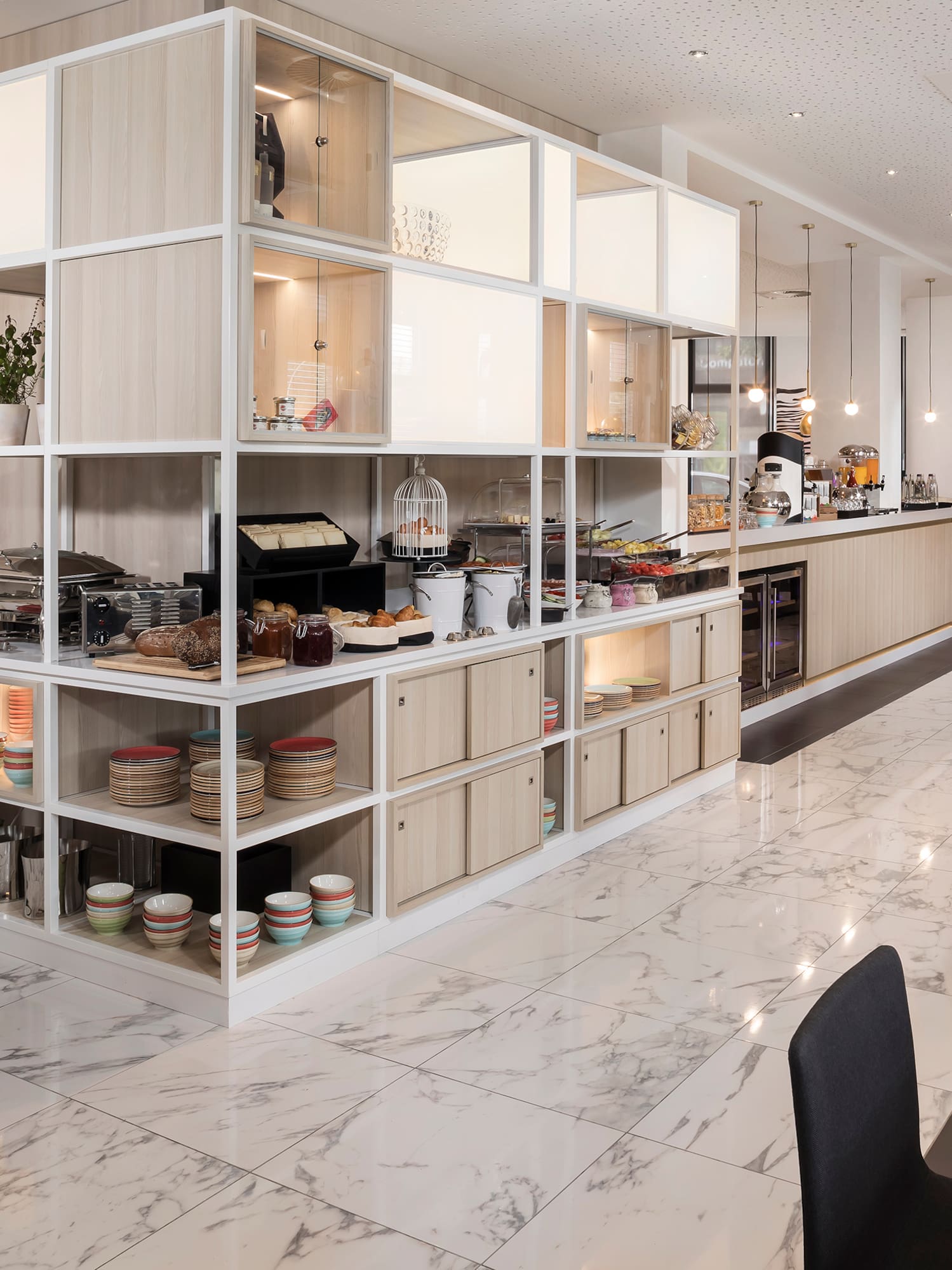 a room with a white wall and shelves