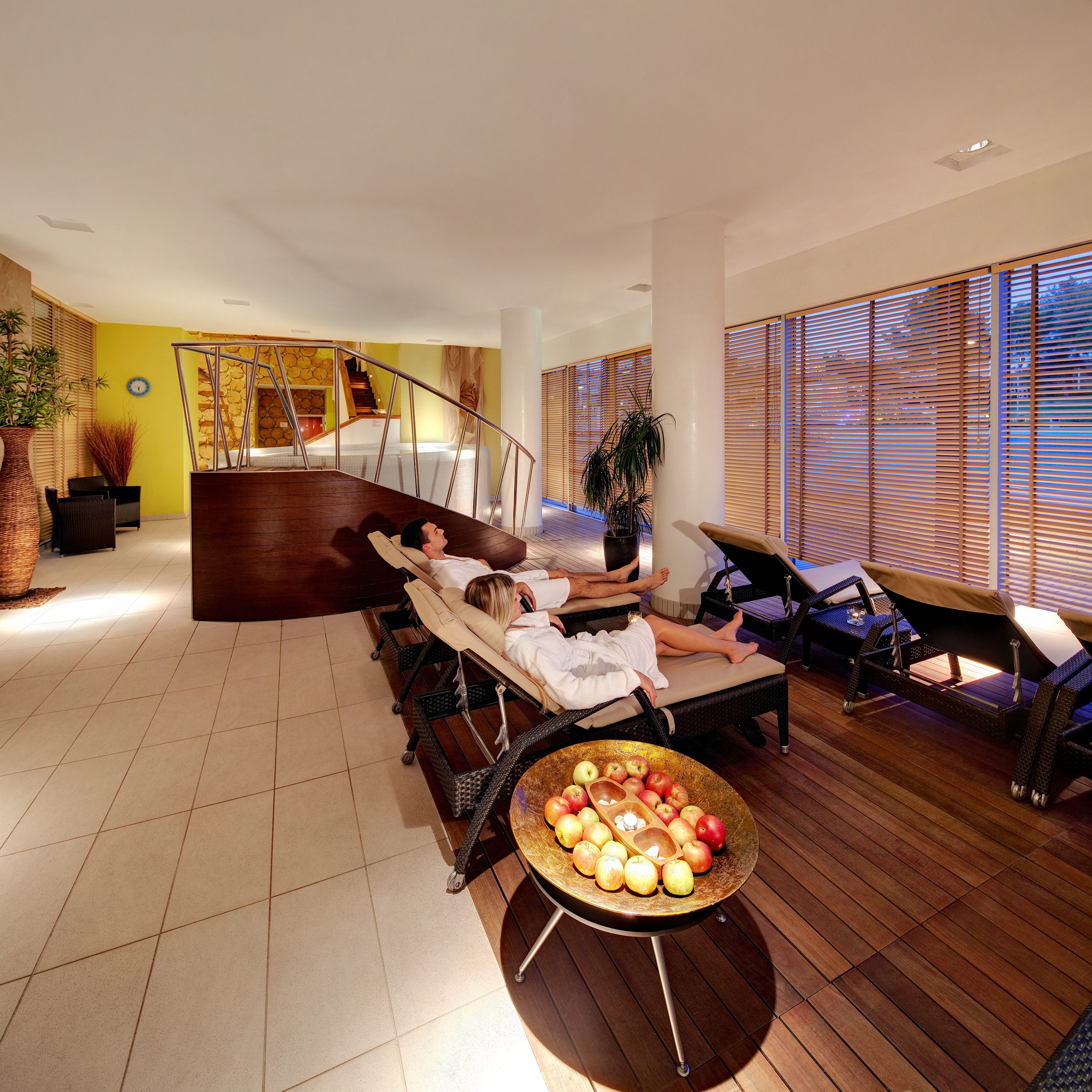 a group of people lying on chairs in a room