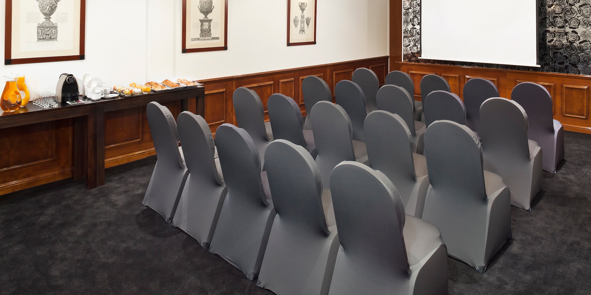 a room with chairs and a screen