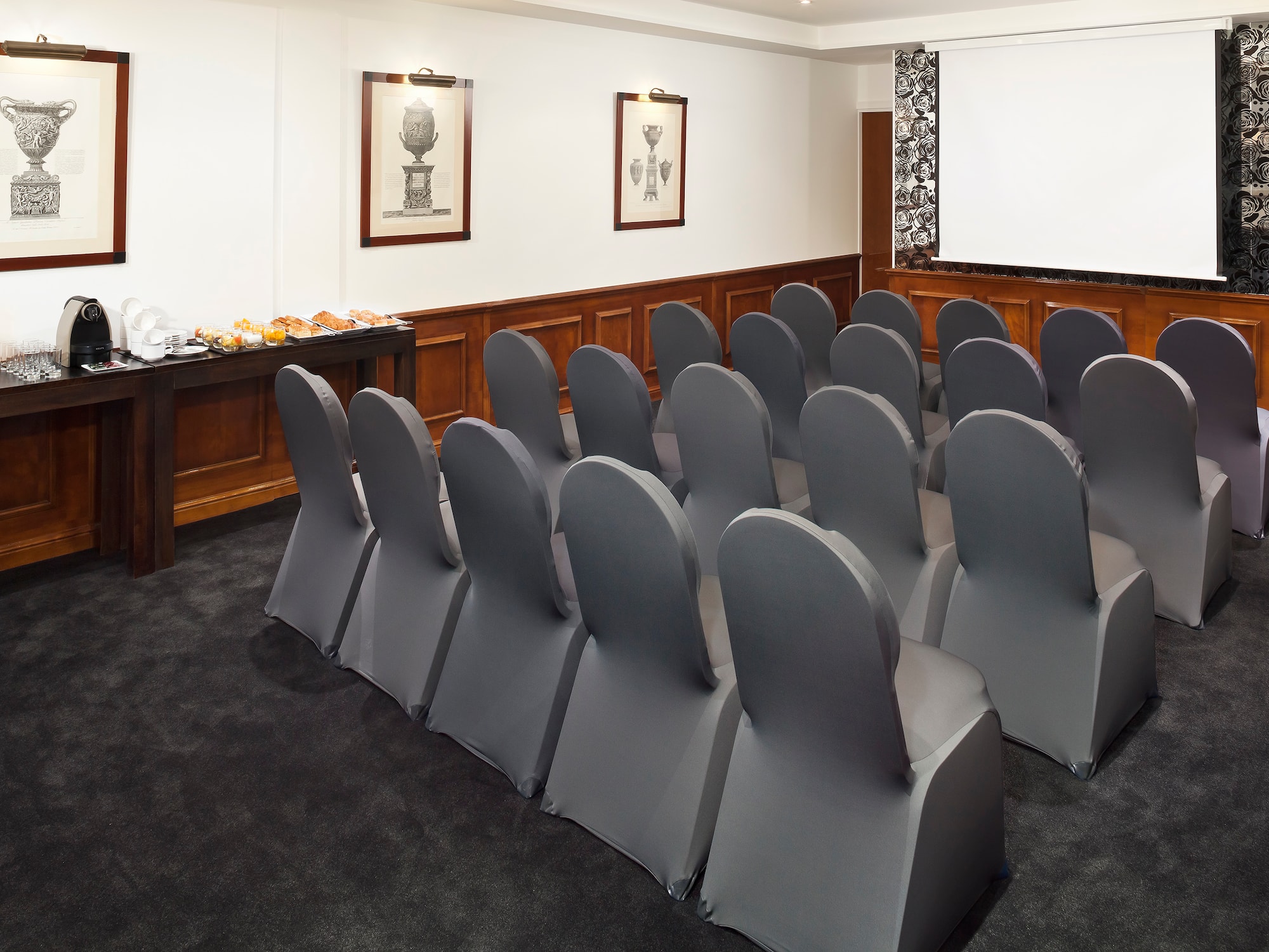 a room with chairs and a screen