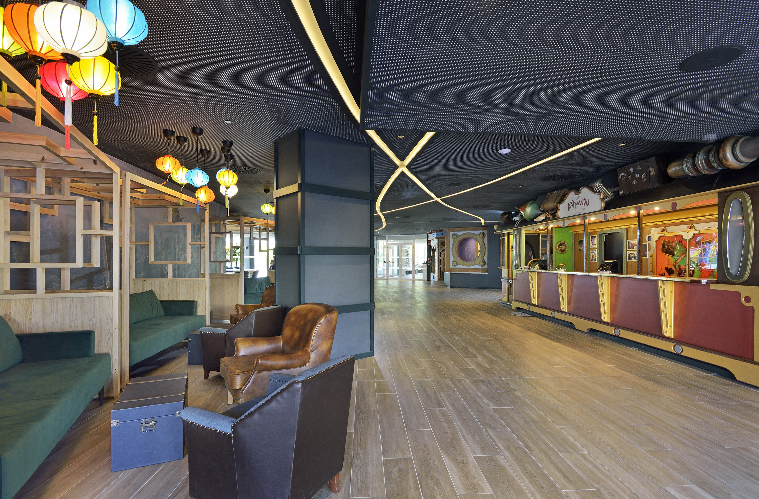 Resort lobby with colorful lanterns, seating area, and Katmandu reception desk.