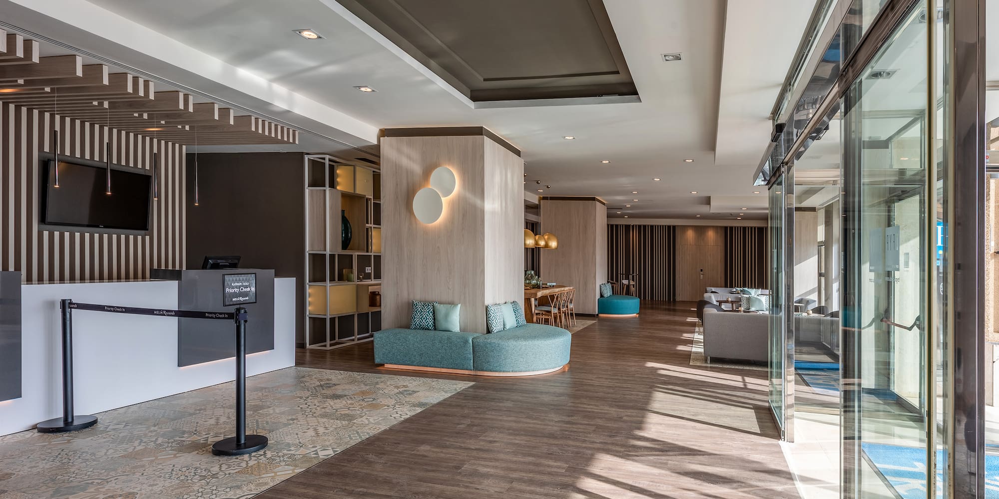 a lobby with a reception desk and a blue couch