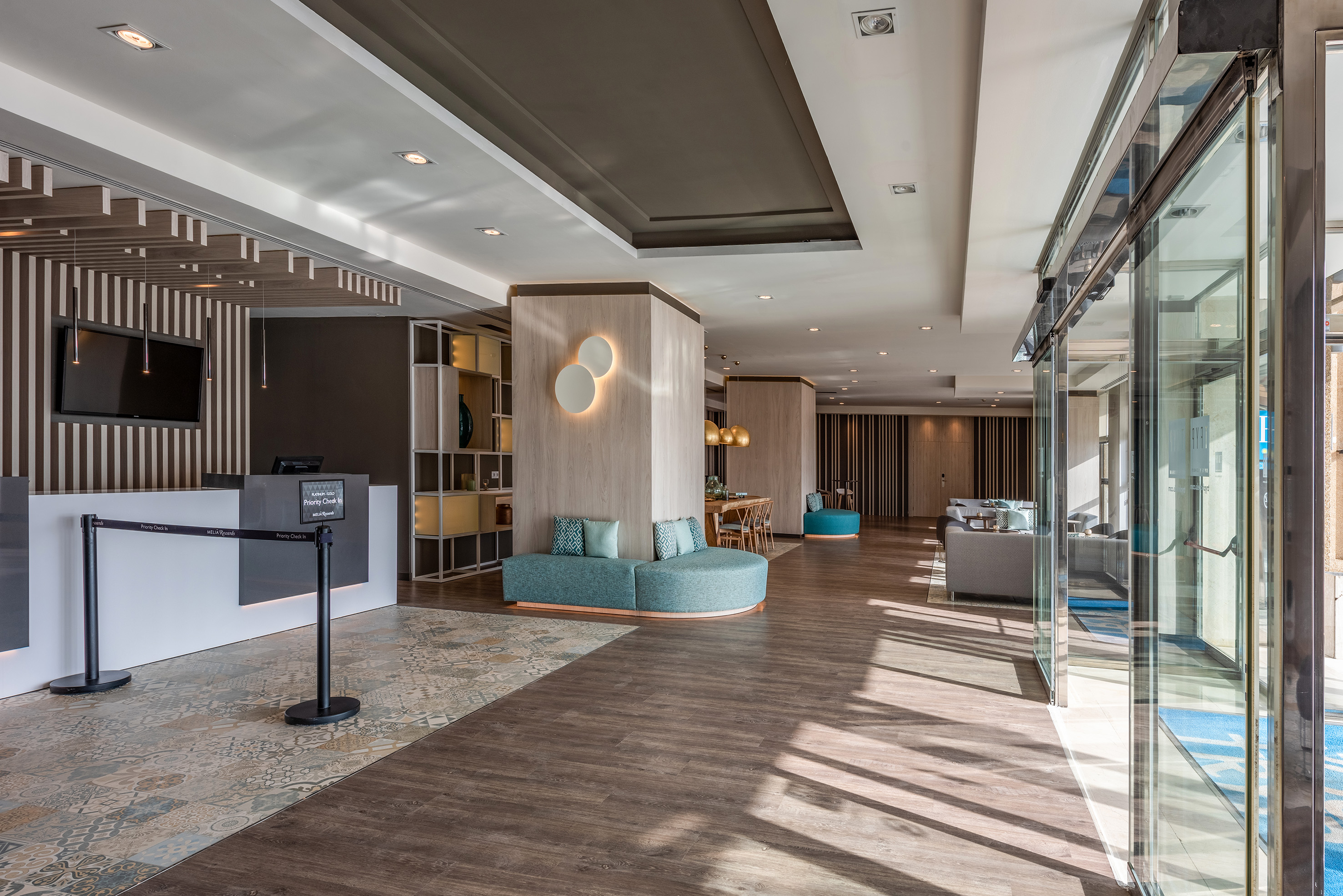 a lobby with a reception desk and a blue couch