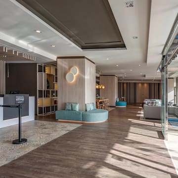 a lobby with a reception desk and a blue couch