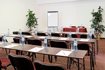 a room with tables and chairs and a white board