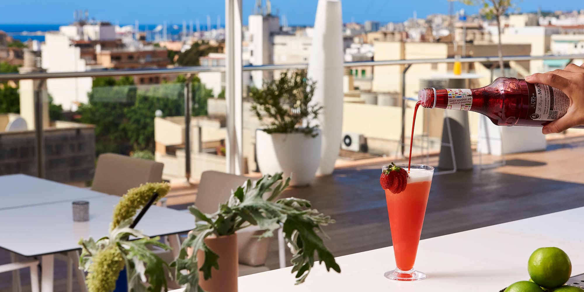 a person pouring a drink into a glass