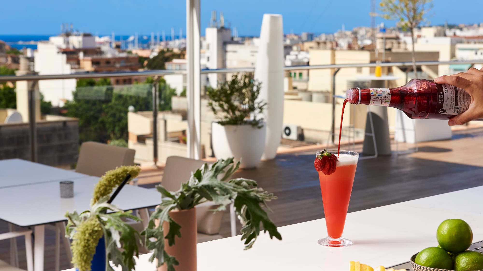 a person pouring a drink into a glass