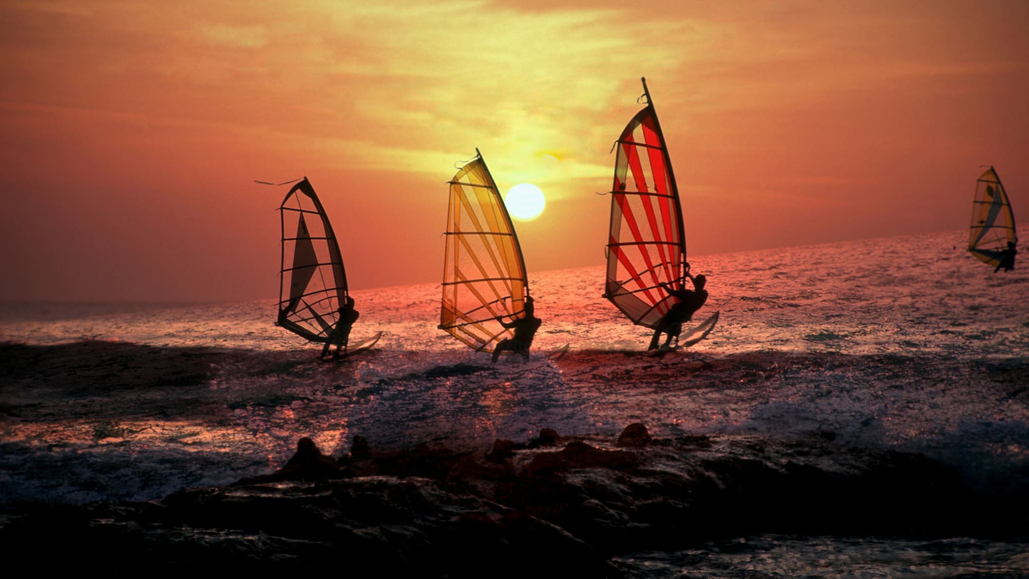 a group of people sailing on the water