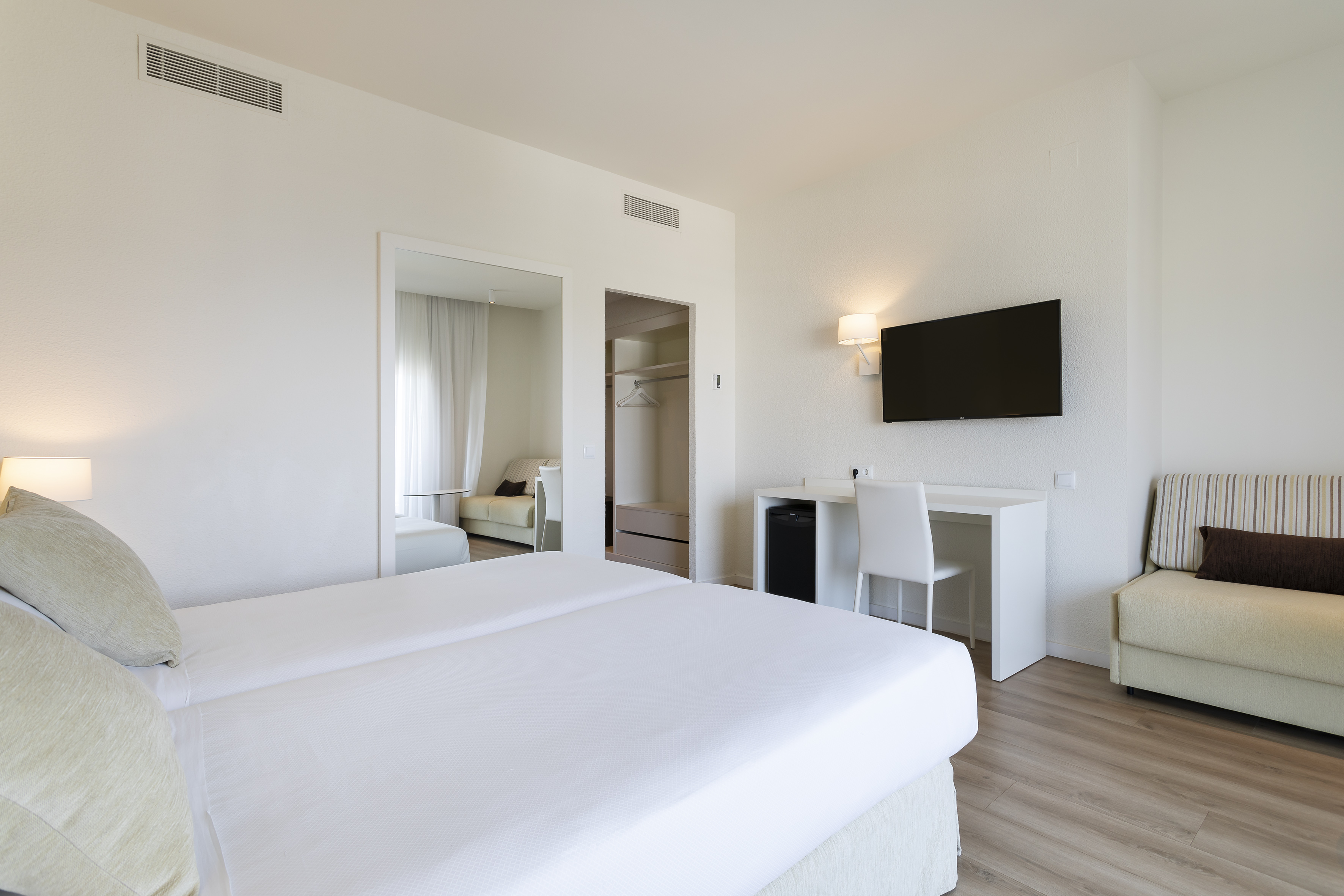 a room with a bed and a tv