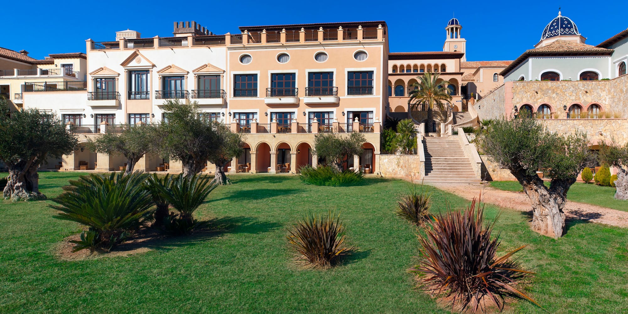 a building with a lawn and bushes
