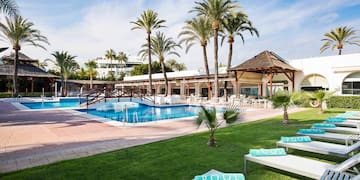 a pool with lounge chairs and palm trees