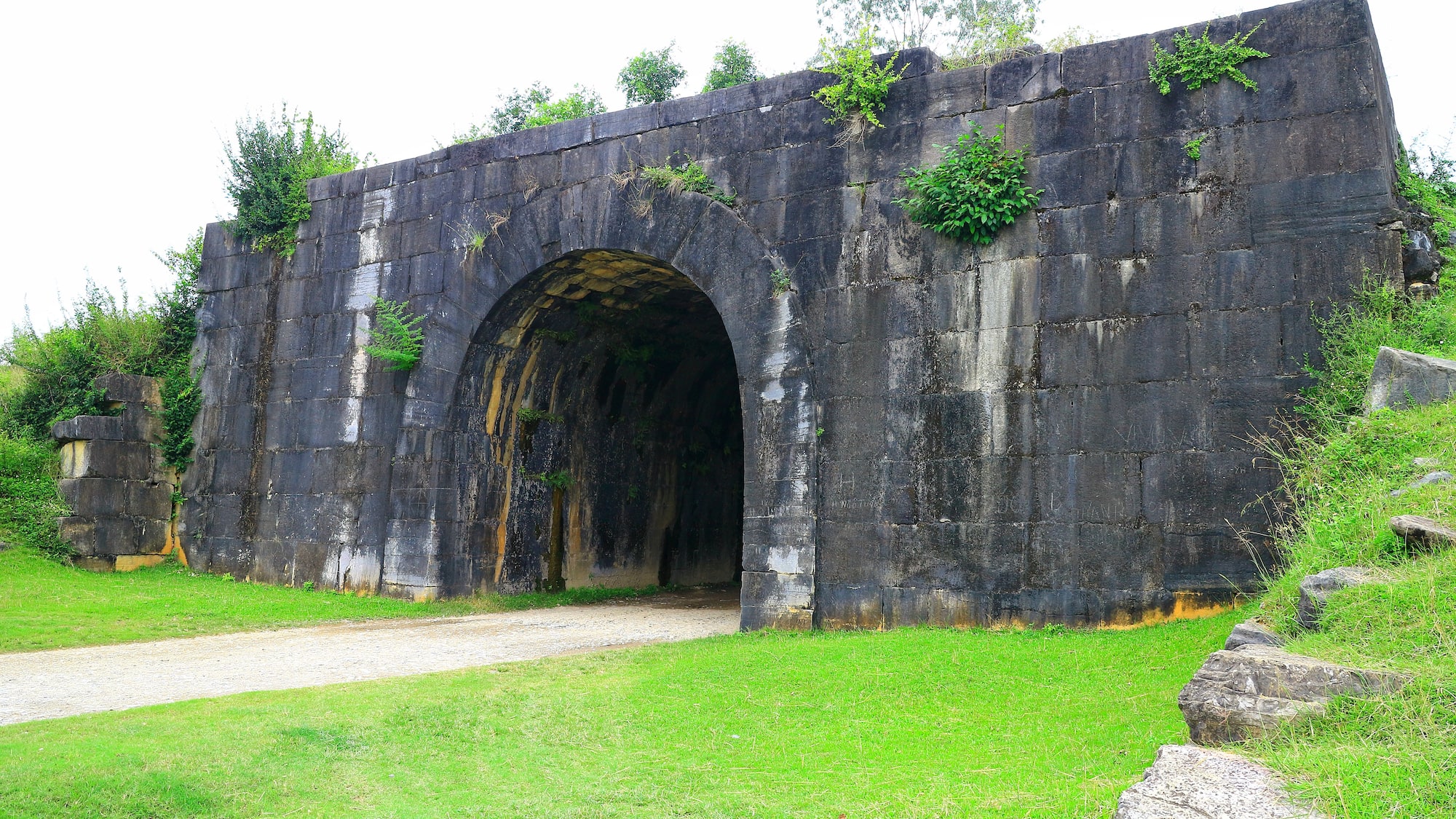 a stone wall with a tunnel