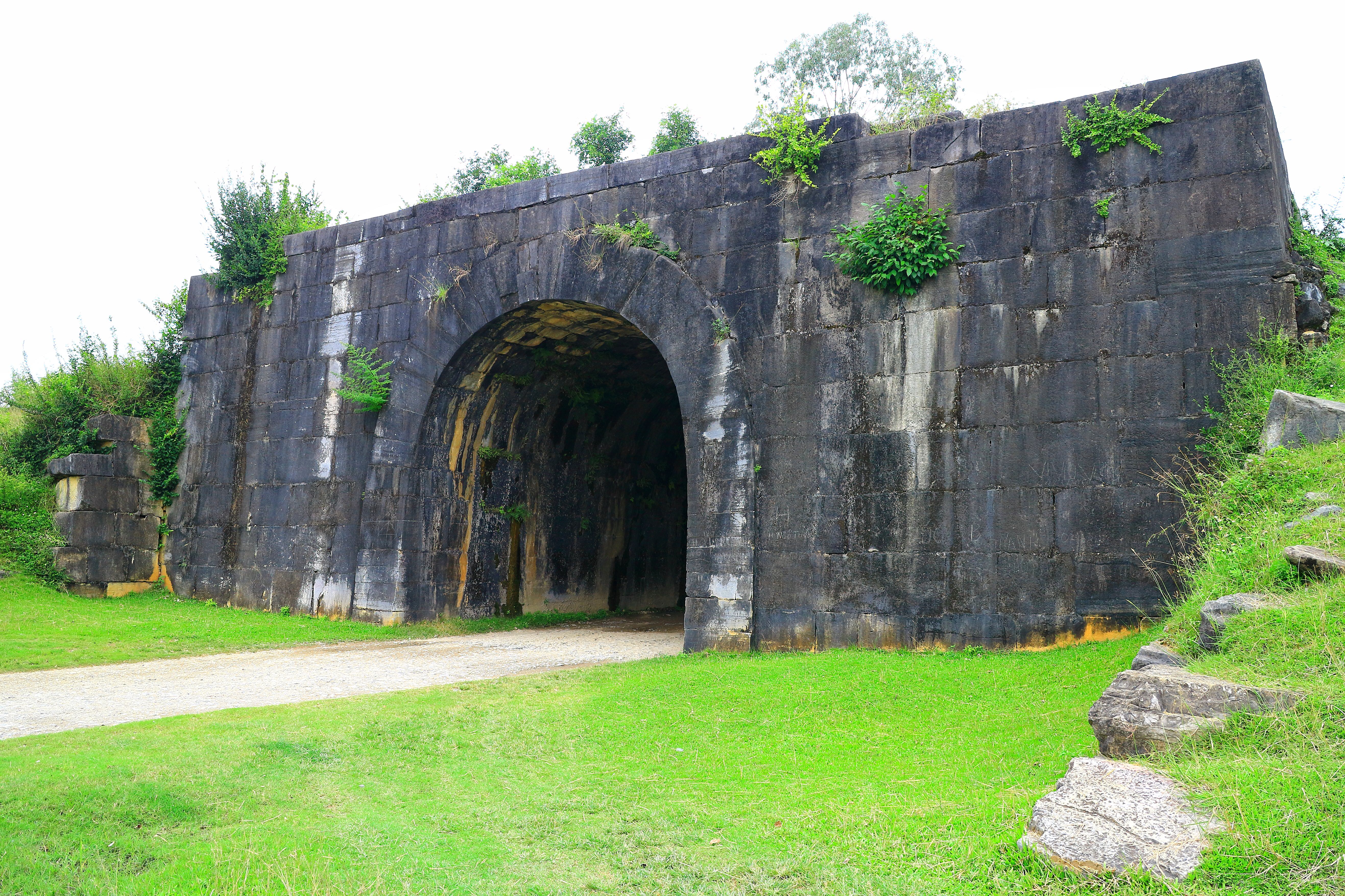 a stone wall with a tunnel