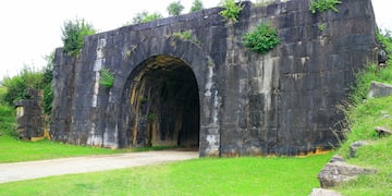 a stone wall with a tunnel