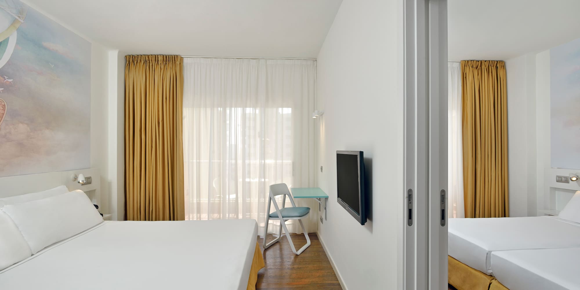 a room with a bed and a tv