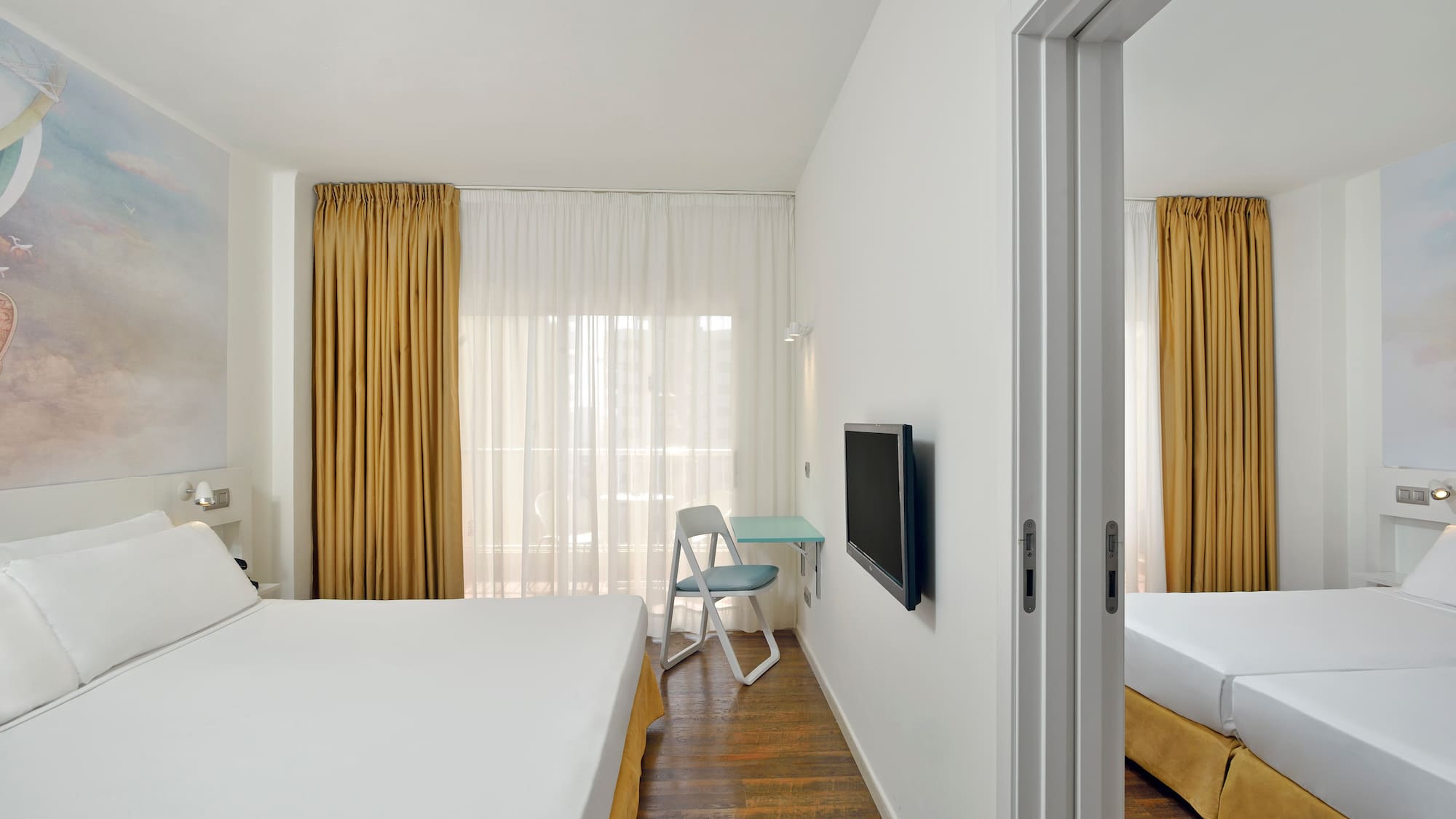 a room with a bed and a tv