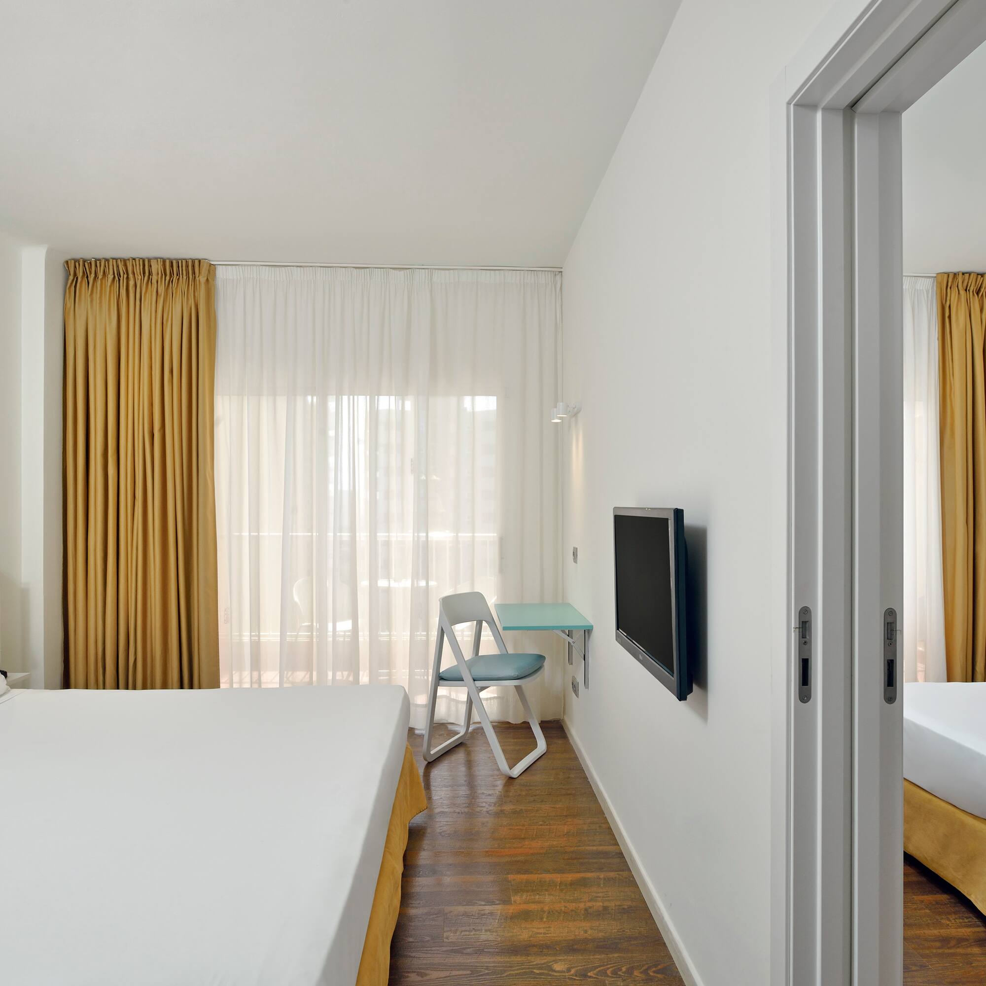 a room with a bed and a tv