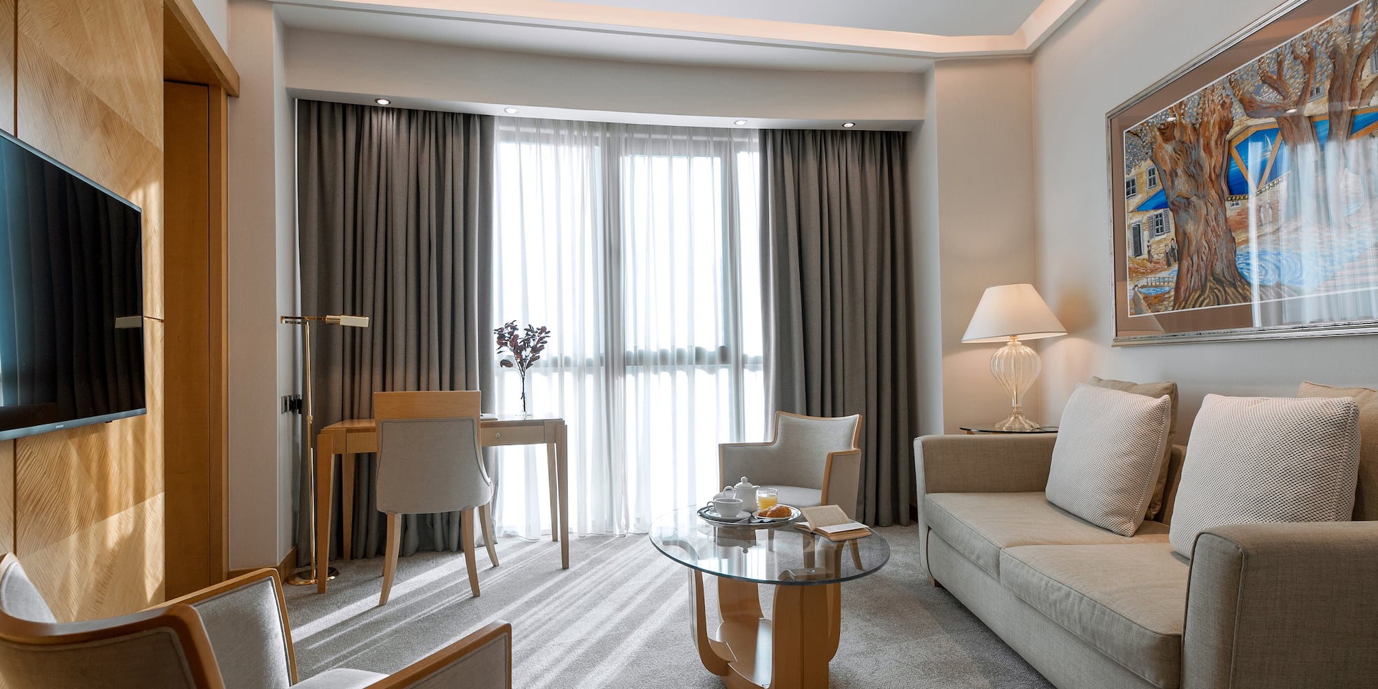 a room with a couch and a table and chairs