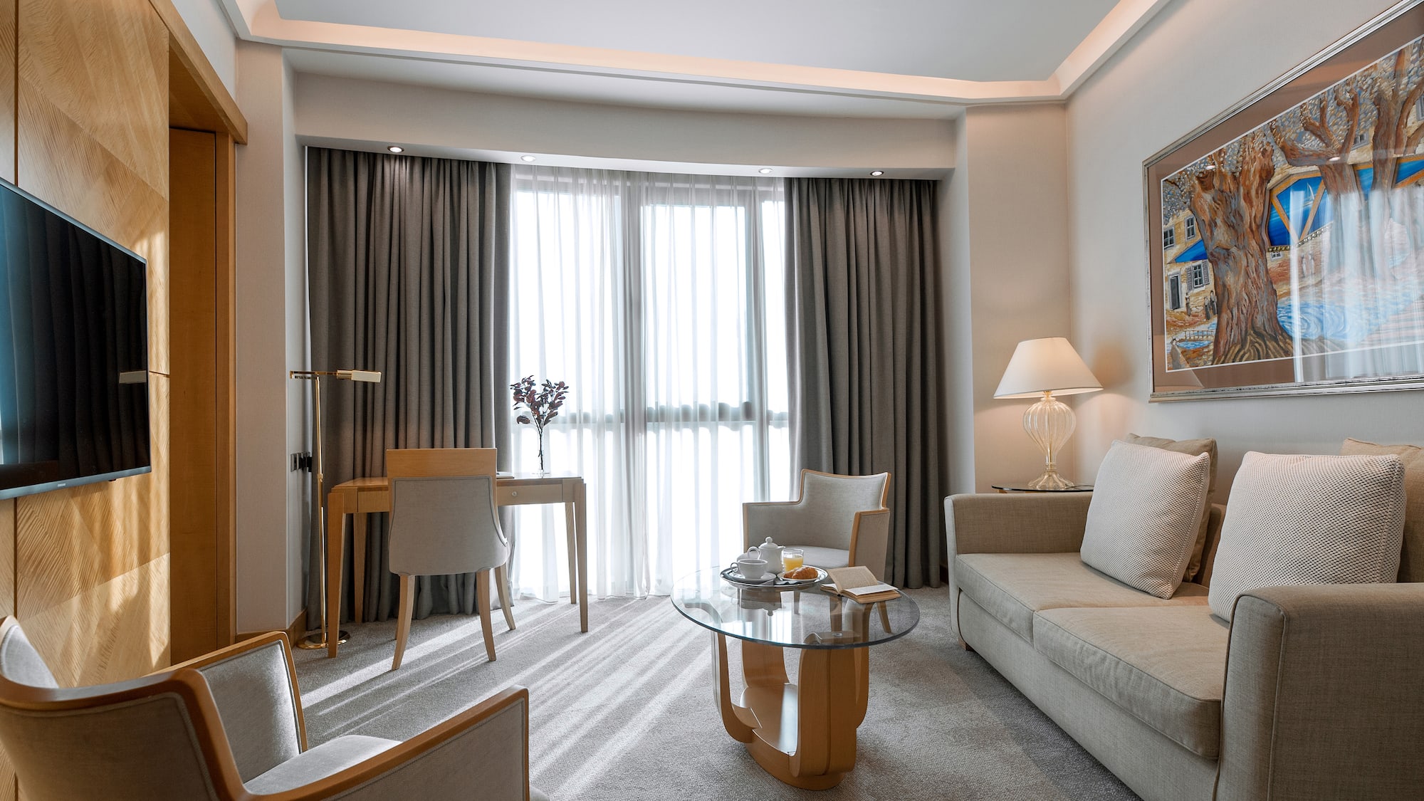 a room with a couch and a table and chairs