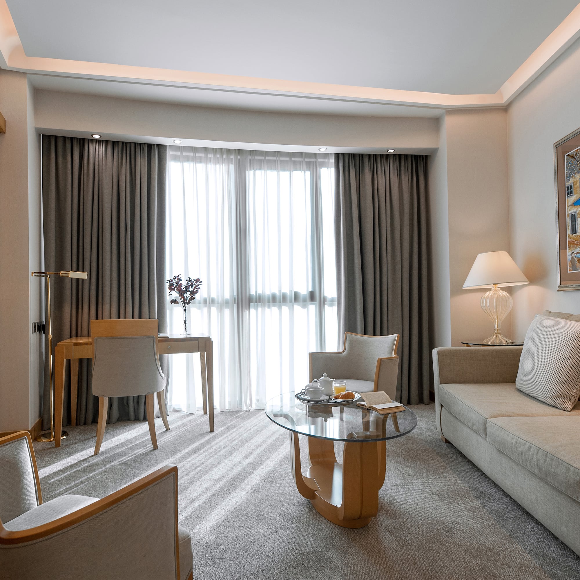 a room with a couch and a table and chairs