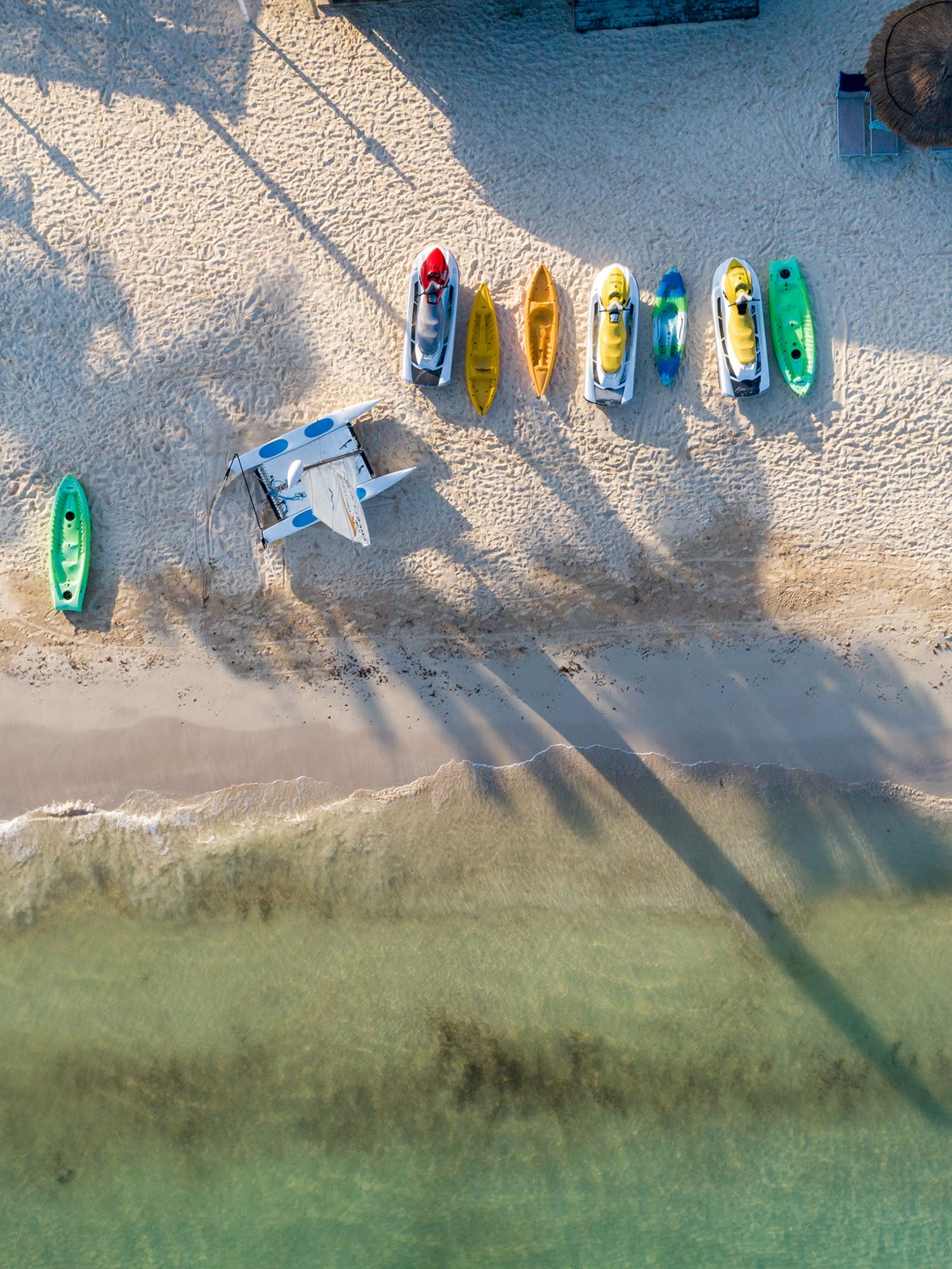 a beach with boats and a plane