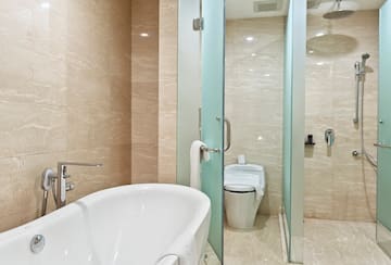 a bathroom with a tub toilet and shower