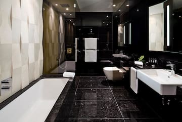 a bathroom with black tile floor